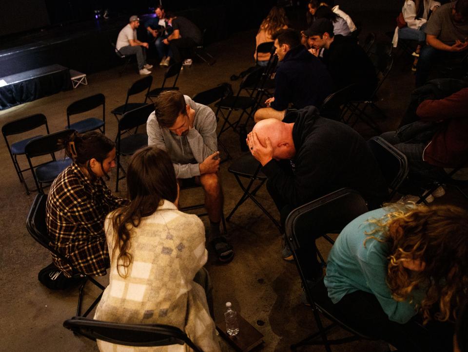 Attendees pray for the victims of the Covenant School shooting during a Tuesday vigil at Church of the City in Nashville, Tenn.