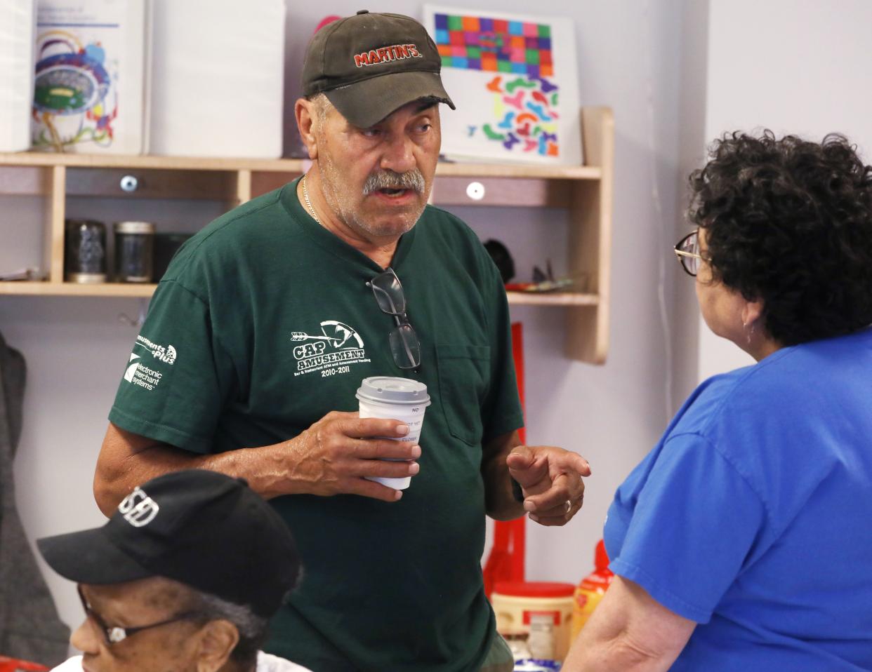 Martin Pedraza talks with Nancy Maciuska during a meeting of the Fairy Grandparents group at the Lewis Street YMCA Neighborhood Center.