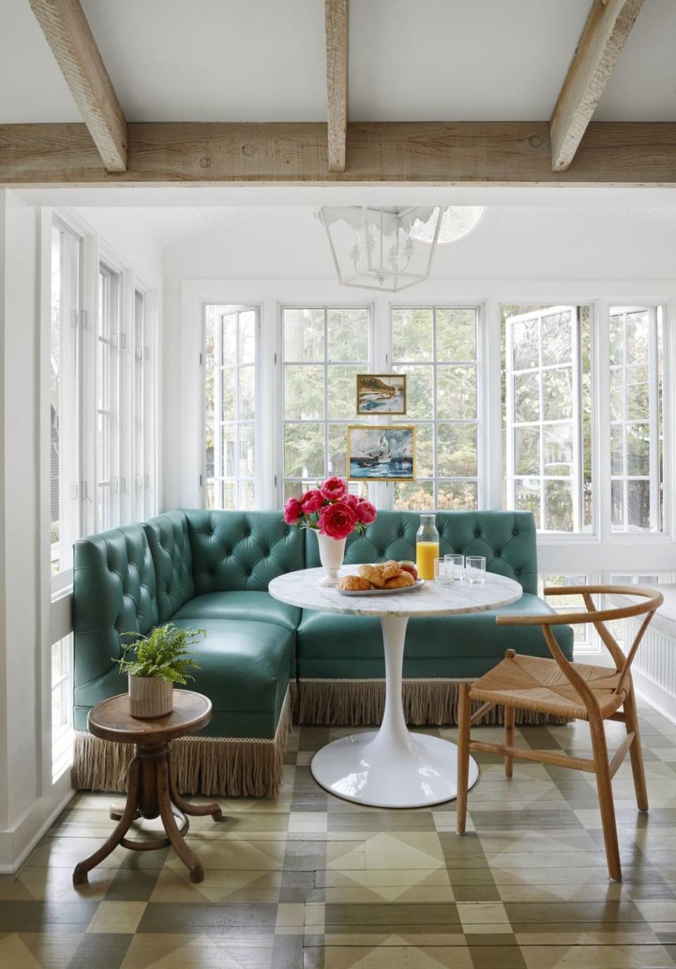 <p>The avocado green floor pattern is original to this charming Michigan cottage. The homeowner loved it so much she hired a specialty painter to copy the existing design onto newly added floorboards after expanding the space. Instead of paint, the pattern is achieved using different shades of stain.</p>