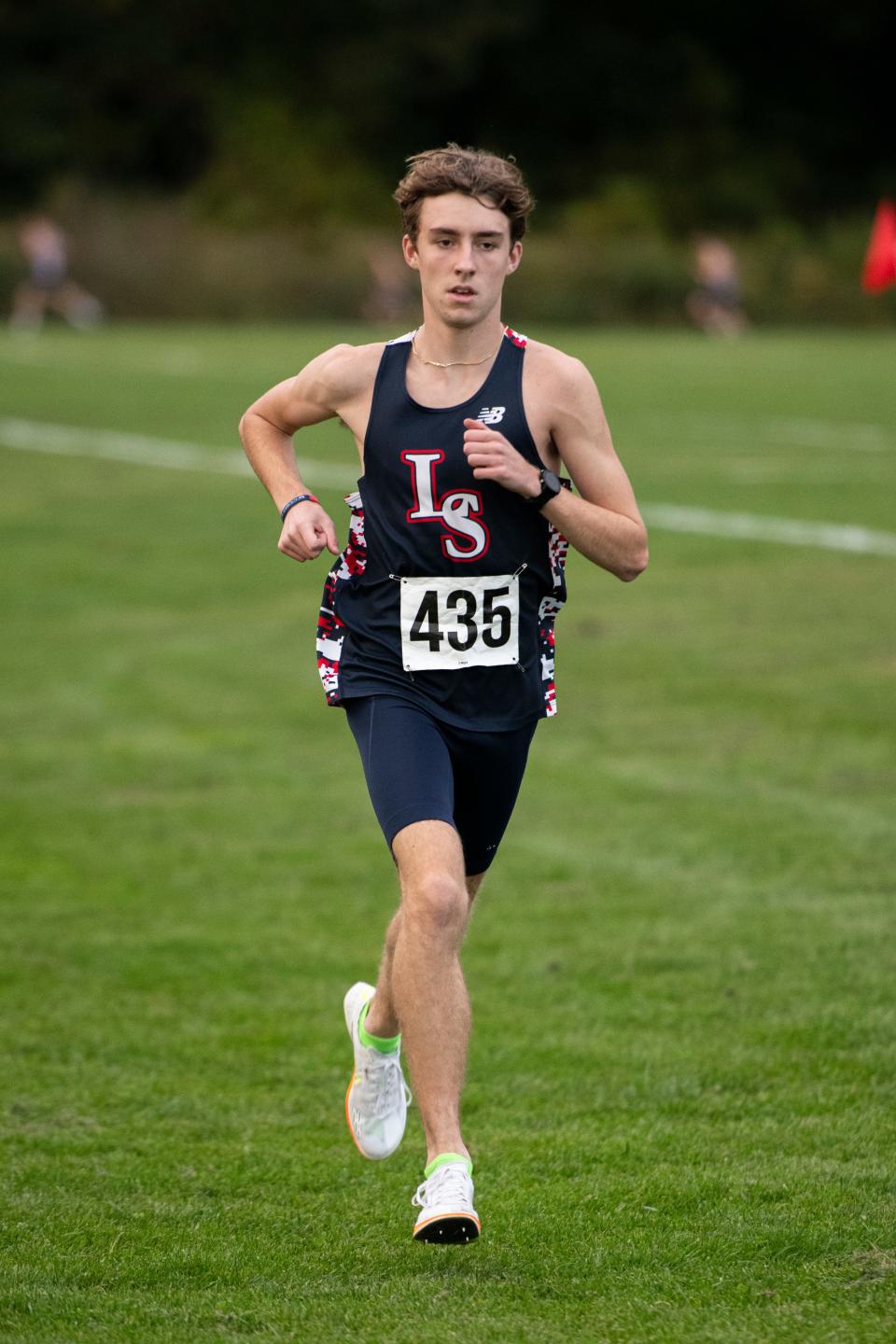 Lincoln-Sudbury junior Ethan Sholk (435) leads the pack during the boys cross country meet in Sudbury against Boston-Latin and Concord-Carlisle, Oct. 11, 2023. Sholk would go on to break the course record with his run.