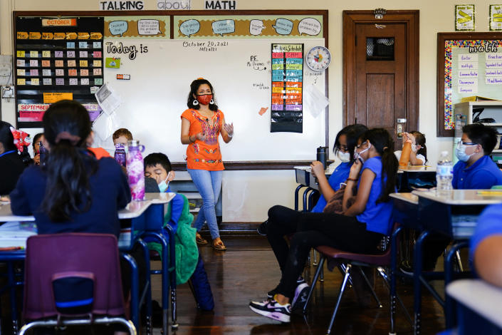 Student teacher Olivia Vazquez leads students through their morning meeting at the Eliza B. Kirkbride School in Philadelphia, Wednesday, Oct. 20, 2021. Vazquez is finishing up her last semester at Swarthmore College and hoping to help make sure immigrant students arriving in Philadelphia have a more supportive experience in school than she did growing up. (AP Photo/Matt Rourke)