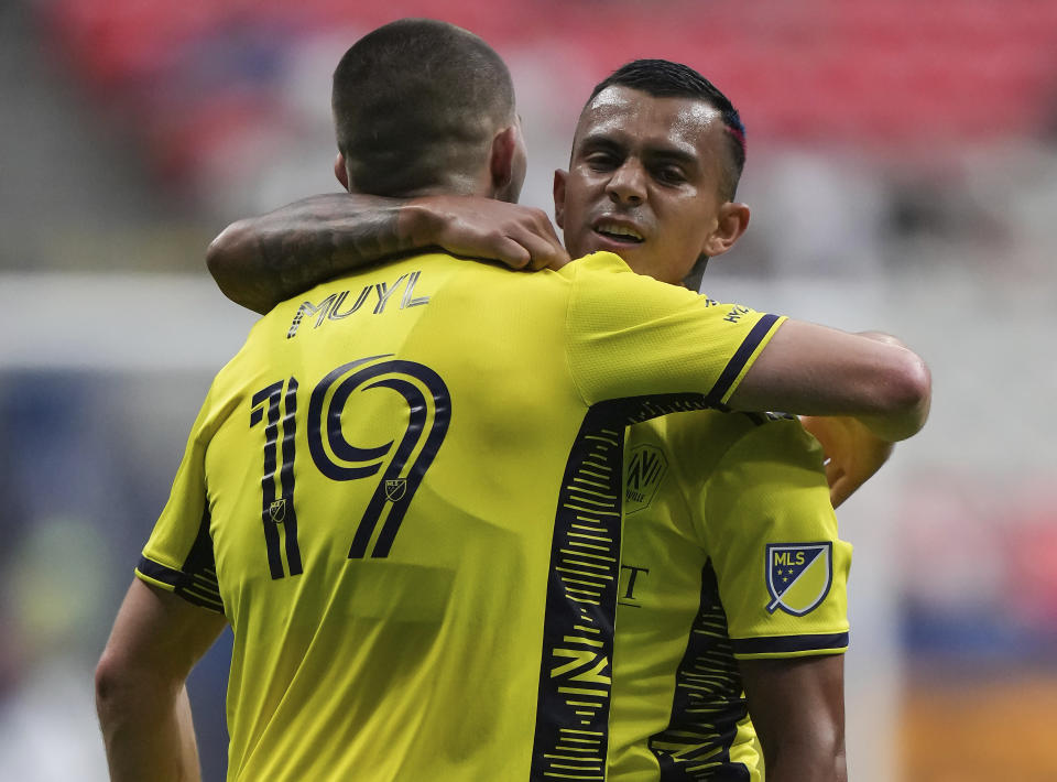 Nashville FC's Randall Leal, right, celebrates his goal against the Vancouver Whitecaps with teammate Alex Muyl during first-half MLS soccer match action in Vancouver, British Columbia, Saturday, Aug. 27, 2022. (Darryl Dyck/The Canadian Press via AP)