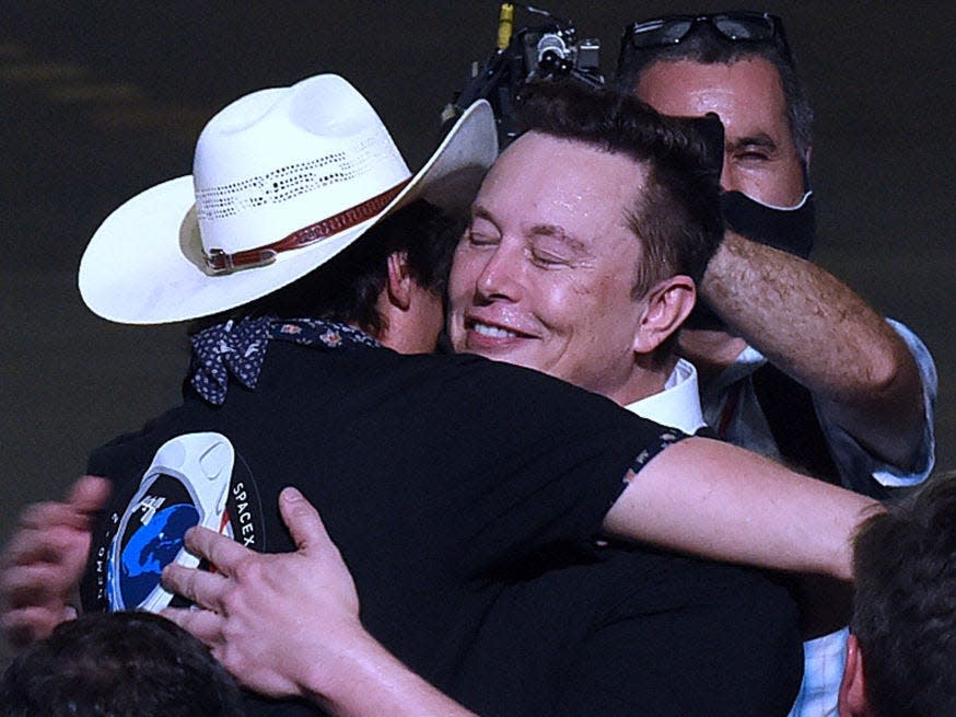 SpaceX founder Elon Musk embraces his brother, Kimbal Musk, after being recognized by U.S. Vice President Mike Pence at NASA's Vehicle Assembly Building following the successful launch of a Falcon 9 rocket with the Crew Dragon spacecraft from pad 39A at the Kennedy Space Center on May 20, 2020.