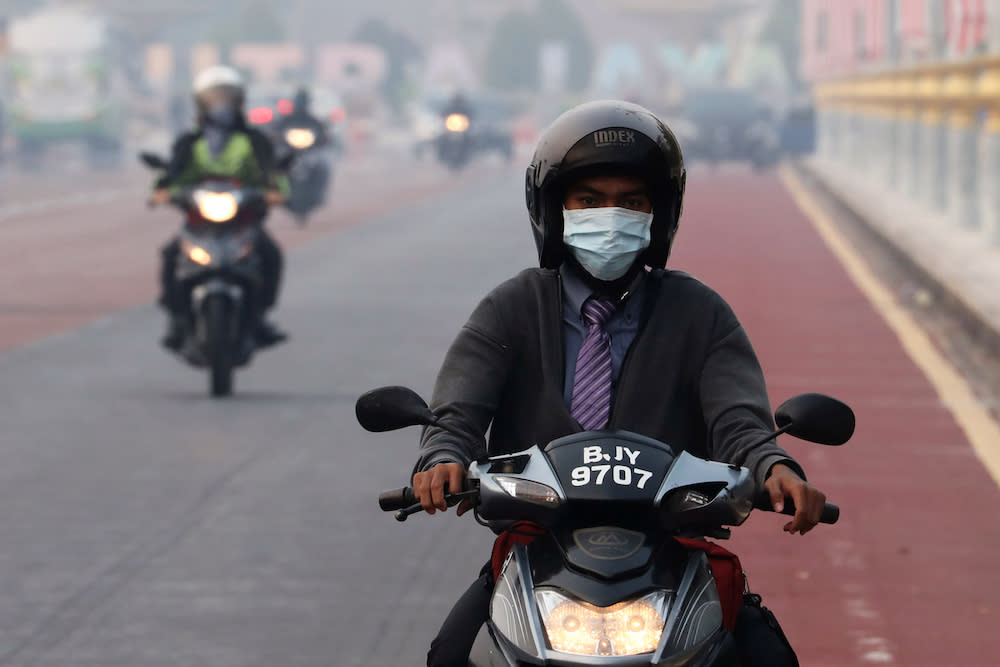 A man rides on a motorcycle in the haze in Putrajaya September 17, 2019. — Reuters pic