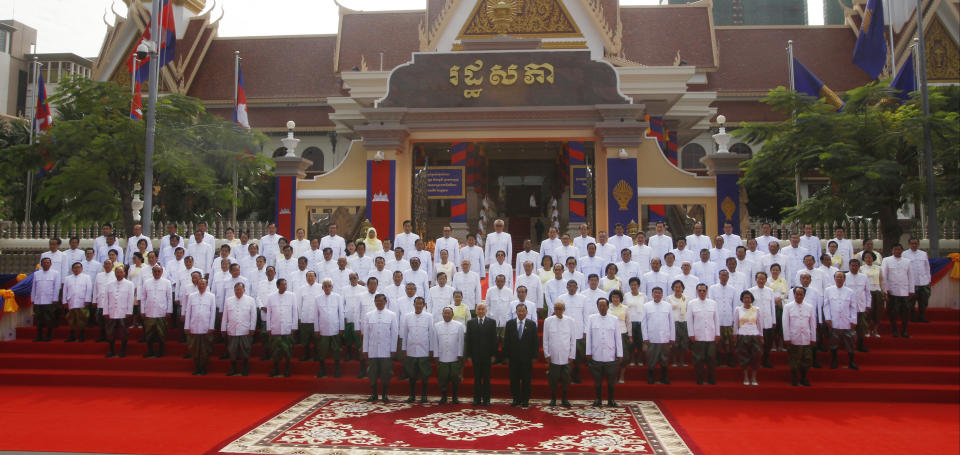 Cambodia's King Norodom Sihamoni, front center, poses with the nation's lawmakers during a photo session in front of the National Assembly in Phnom Penh, Cambodia, Wednesday, Sept. 5, 2018. Cambodian King Norodom Sihamoni on Wednesday presided over the opening of the first session of National Assembly to ensure long-ruling Prime Minister Hun Sen another term after his party swept election in late July. (AP Photo/Heng Sinith)