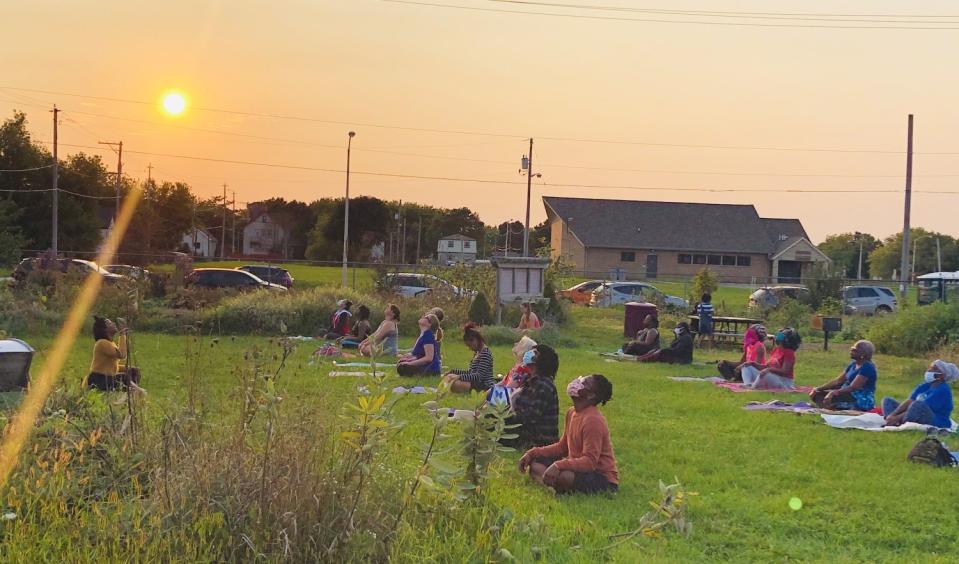 Visitors to Alice's Garden do yoga on its grassy lawn.