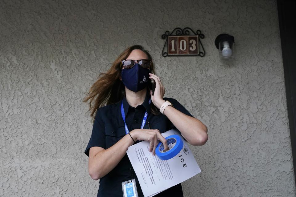 Pima County Constable Kristen Randall arrives at an apartment complex to speak to a rental resident about their eviction case Friday, Sept. 24, 2021, in Tucson, Ariz. Long delayed evictions are rolling out more than a month after the end of a federal moratorium that had protected tenants, including some who hadn't paid rent for many months during the coronavirus pandemic. (AP Photo/Ross D. Franklin)