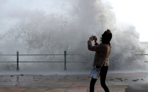 waves crash up onto Penzance seafront  - Credit: Matt Cardy/Getty