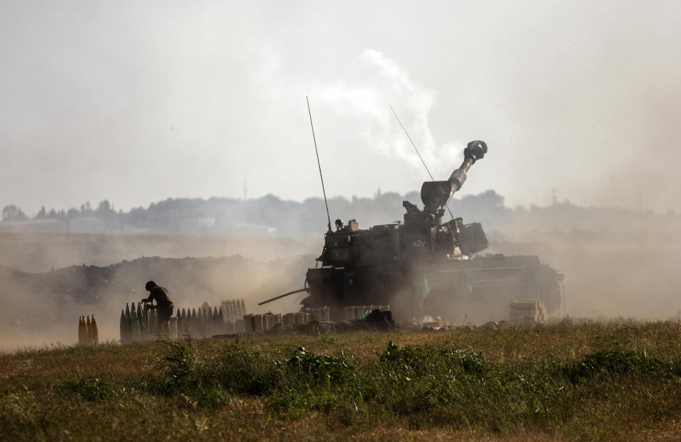 An Israeli artillery unit fires toward targets in the Gaza Strip, at the Israeli-Gaza border, Sunday, May 16, 2021. (AP Photo/Heidi Levine)