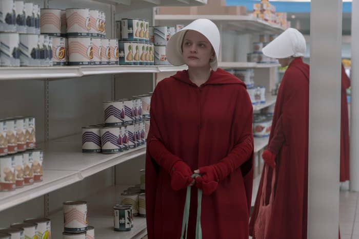 Ellsabeth walking down a grocery aisle in The Handmaid's Tale