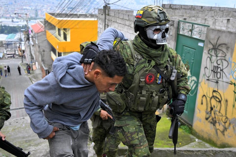 Members of the Army detain a man during a patrol in the Lucha de los Pobres neighbourhood in southern Quito. President Daniel Noboa has declared the country to be in a 'state of war' (AFP via Getty Images)