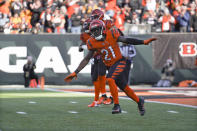 Cincinnati Bengals cornerback Mike Hilton (21) celebrates an interception of a pass intended for Pittsburgh Steelers wide receiver James Washington (13) during the first half of an NFL football game, Sunday, Nov. 28, 2021, in Cincinnati. Hilton returned the ball for a touchdown. (AP Photo/Jeff Dean)