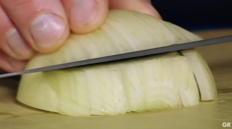 gordon ramsay slicing horizontally into an onion