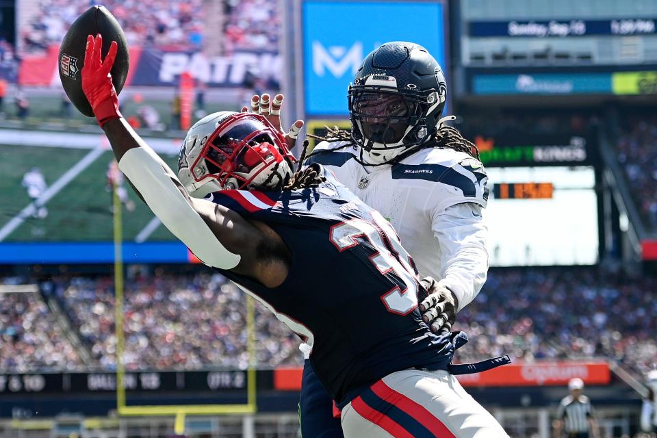 FOXBOROUGH, MASSACHUSETTS - SEPTEMBER 15: Rhamondre Stevenson #38 of the New England Patriots attempts to catch a pass against Jerome Baker #17 of the Seattle Seahawks during the first half at Gillette Stadium on September 15, 2024 in Foxborough, Massachusetts. (Photo by Jaiden Tripi/Getty Images)