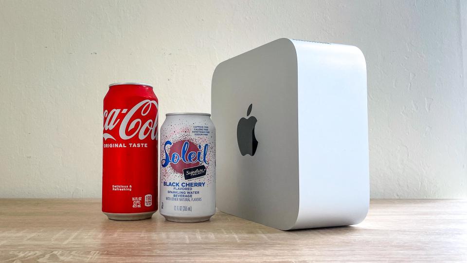 Mac Studio standing on its side next to soda cans