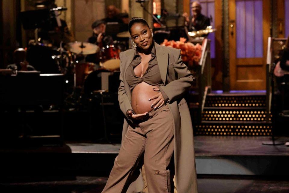 Keke Palmer reveals her baby bump during the opening monologue of the Dec. 3, 2022 episode of "Saturday Night Live."