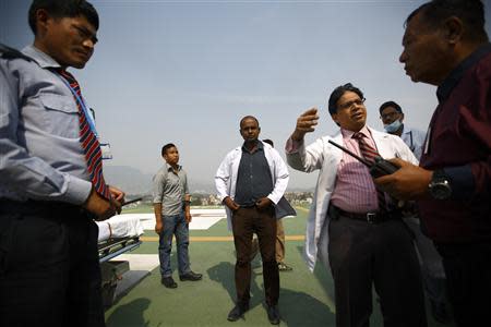 Doctors expecting the arrival of the victims of a Mount Everest avalanche standby near the helipad at Grandi International Hospital in Kathmandu April 18, 2014. REUTERS/Navesh Chitrakar