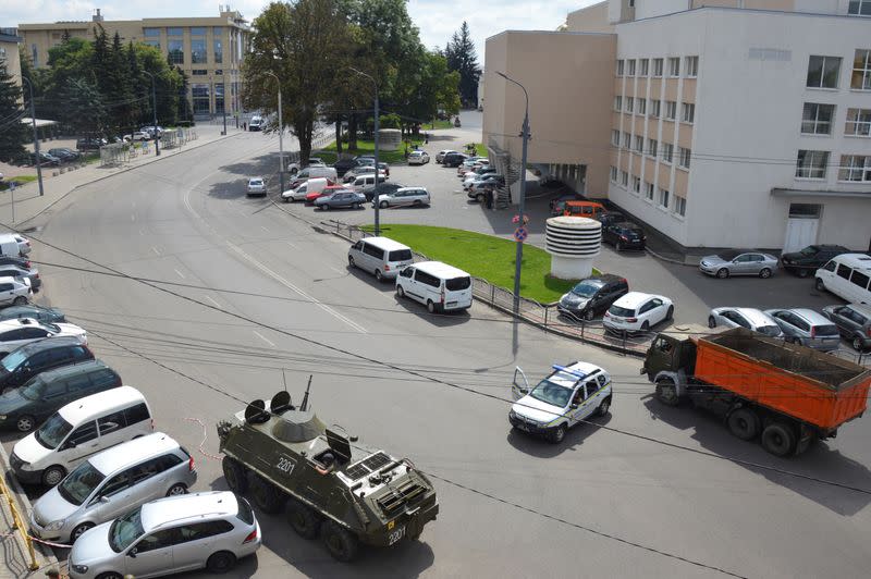 Officers take part in a hostage rescue operation after an unidentified person seized a passenger bus in Lutsk