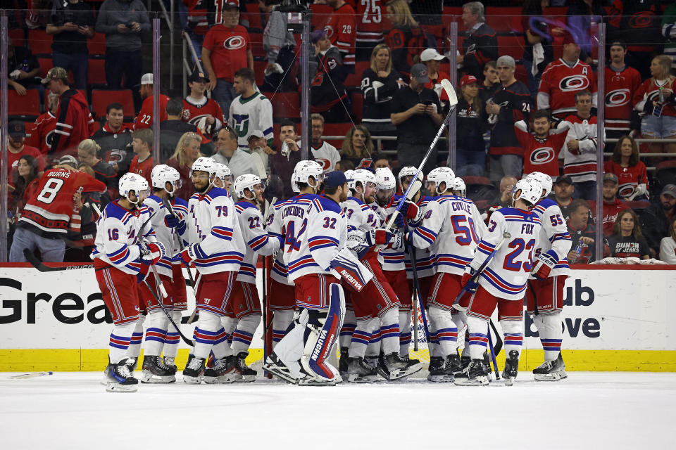 New York Rangers celebrate a win over the Carolina Hurricanes in Game 6 of an NHL hockey Stanley Cup second-round playoff series in Raleigh, N.C., Thursday, May 16, 2024. The Rangers advanced to the Eastern Conference final. (AP Photo/Karl B DeBlaker)