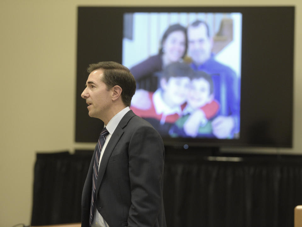 Attorney Chris Mattei shows a photograph of the Wheeler family during closing statements in the Alex Jones Sandy Hook defamation damages trial in Superior Court in Waterbury, Conn., on Thursday, Oct. 6, 2022. (H John Voorhees III/Hearst Connecticut Media via AP, Pool)