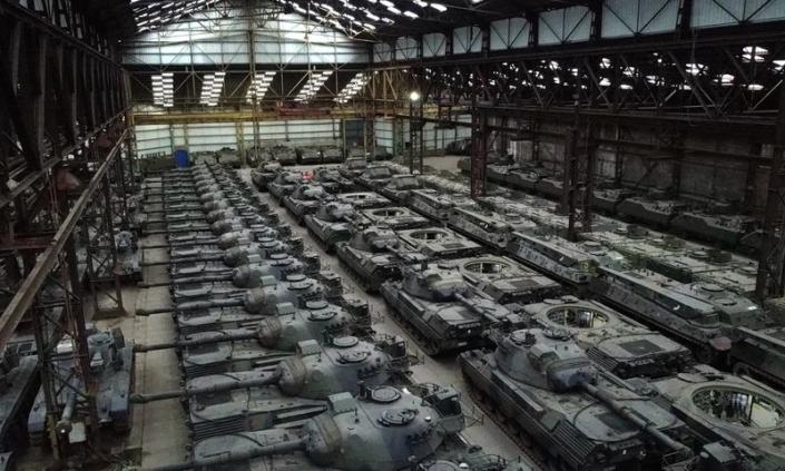 Dozens of German-made Leopard 1 tanks and other armoured vehicles are seen in an hangar in Tournais