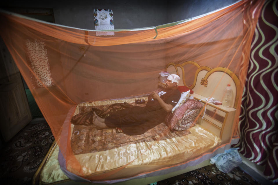 Manzoor Ahmad Dar rests inside a Mosquito net as he was injured in a bear attack inside his house at Khimber village in Srinagar, Indian controlled Kashmir, Sunday, Sept. 6, 2020. A 36 year old Kashmiri farmer Manzoor Ahmad dar receives serious head injury outside his home as wild black bear appears at his kitchen garden outside his home as Dar and his uncle Abdul Ahad Dar aged 55 years old soon after the attack our of close neighbor was also receive injuries . Villagers chased the bear and he got disappeared soon after the attack. (AP Photo/Mukhtar Khan)