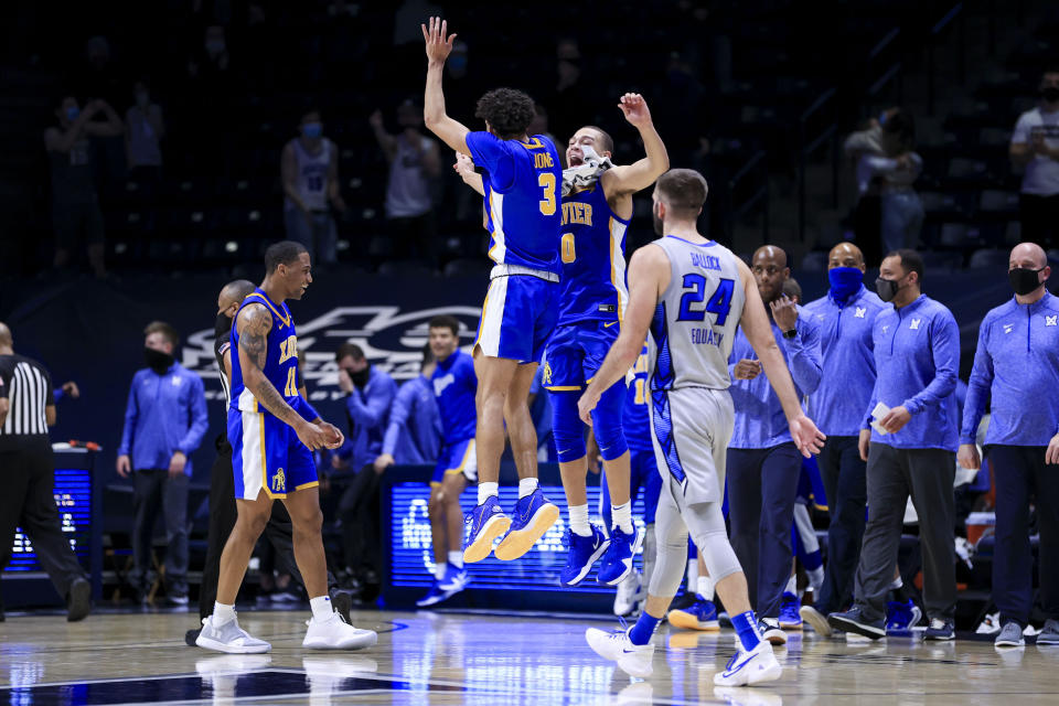 Xavier guards Colby Jones, left, and C.J. Wilcher (0) celebrate the team's 77-69 win over Creighton in an NCAA college basketball game Saturday, Feb. 27, 2021, in Cincinnati. (AP Photo/Aaron Doster)