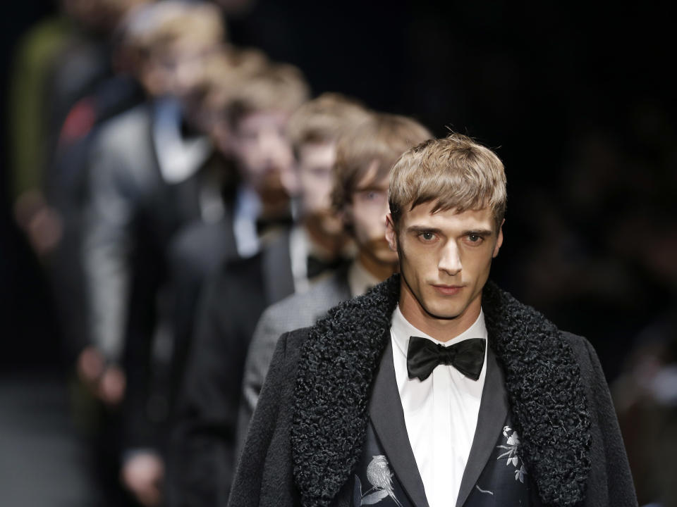 Models wear creations for Gucci men's Fall-Winter 2013-14 collection, part of the Milan Fashion Week, unveiled in Milan, Italy, Monday, Jan. 14, 2013. (AP Photo/Antonio Calanni)