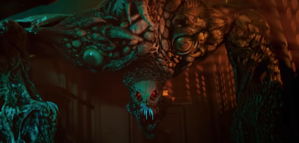 A still from Resident Evil: Welcome to Raccoon City shows a monsterous zombie looming towards us