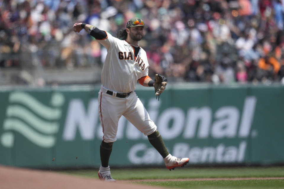 San Francisco Giants shortstop Brandon Crawford throws out Miami Marlins' Bryan De La Cruz at first base during the first inning of a baseball game in San Francisco, Sunday, May 21, 2023. (AP Photo/Jeff Chiu)