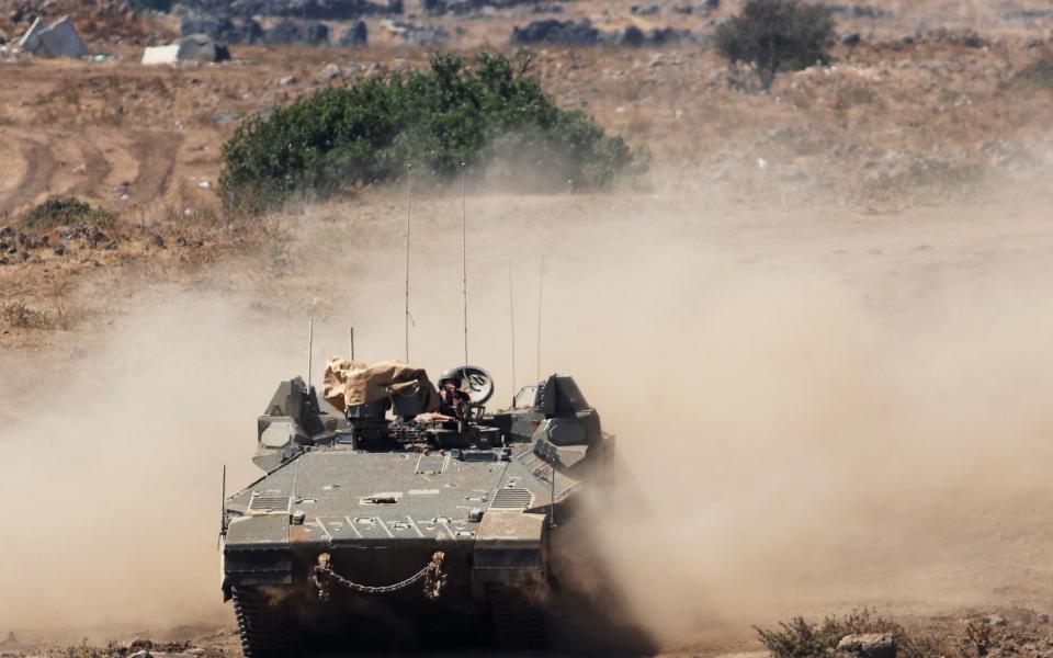 An Israeli military armoured personnel carrier (APC) manoeuvres in the Israeli-controlled Golan Heights near the Israel-Syria frontier - Reuters