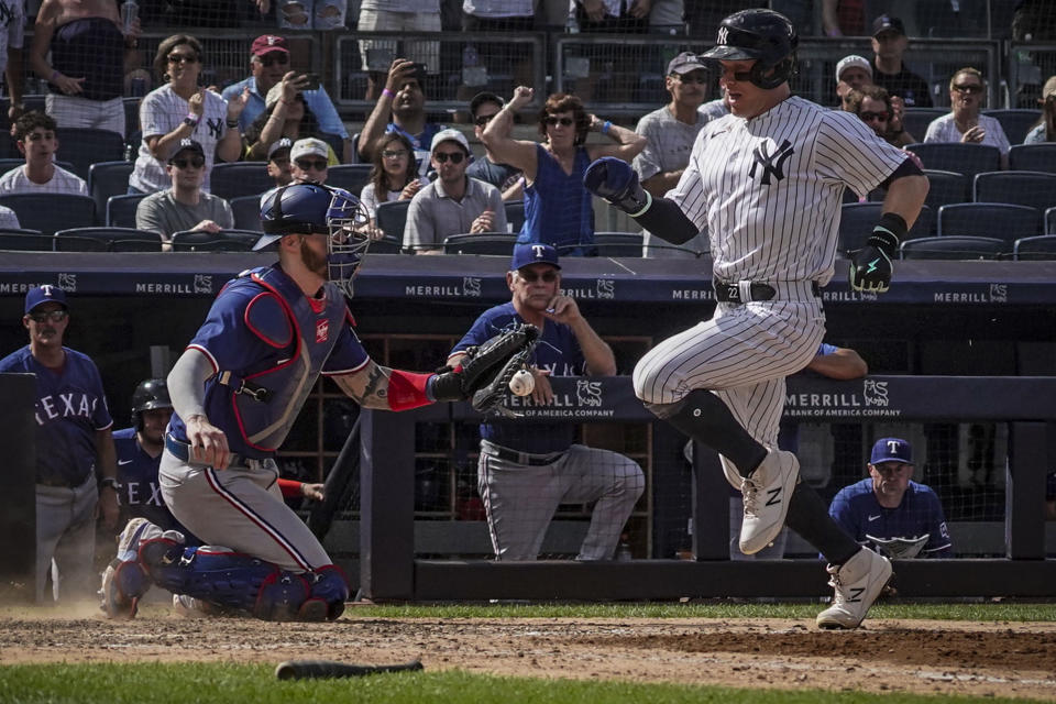 New York Yankees' Harrison Bader beats a throw to Texas Rangers catcher Jonah Heim and scores during the eighth inning of a baseball game, Sunday, June 25, 2023, in New York. (AP Photo/Bebeto Matthews)