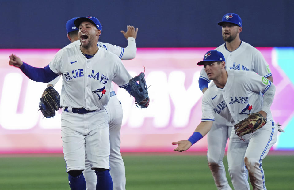 Toronto Blue Jays players, from left, George Springer, Whit Merrifield, Daulton Varsho and Nathan Lukes celebrate after defeating the Philadelphia Phillies in a baseball game in Toronto on Tuesday, Aug. 15, 2023. (Nathan Denette/The Canadian Press via AP)