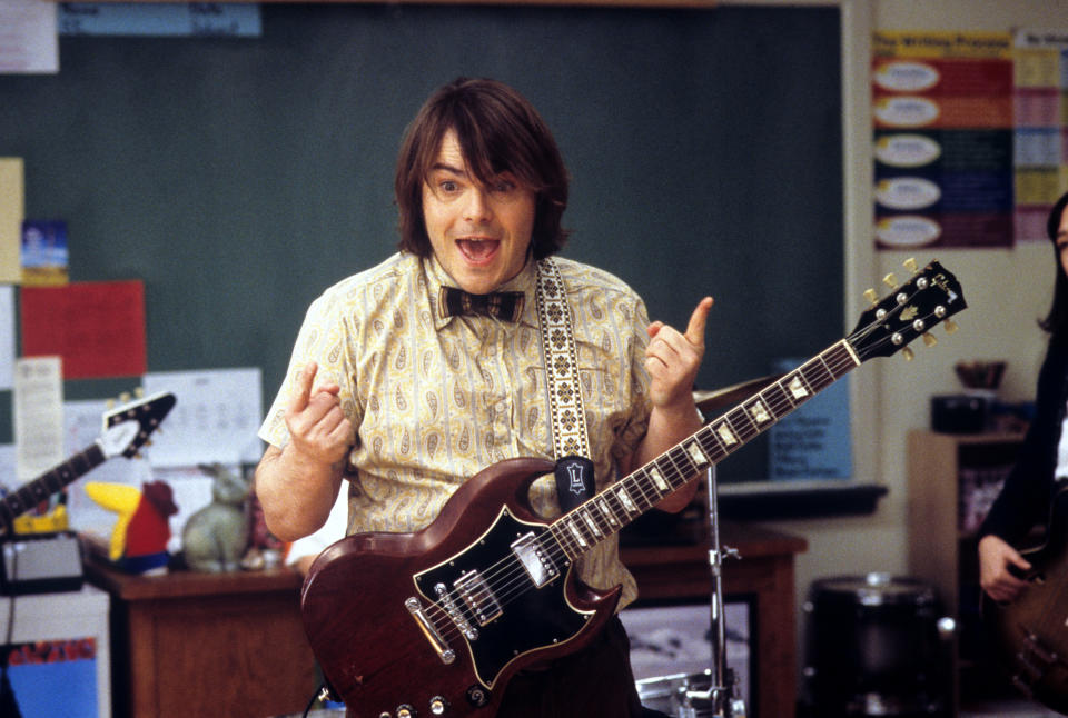 man in the classroom with a guitar