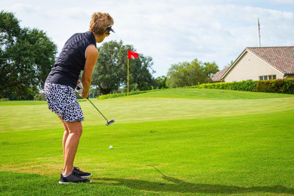 Carol Simon from Delray Beach putts toward the pin on the golf course at the Westchester Golf Club in Boynton Beach.