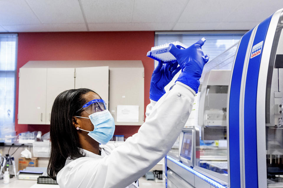 Clinical lab scientist Selam Bihon processes upper respiratory samples from patients suspected of having COVID-19 at the Stanford Clinical Virology Laboratory on Wednesday, Feb. 3, 2021, in Palo Alto, Calif. Viruses mutate constantly. To stay ahead of the threat, scientists analyze samples for genetic changes, watching closely for ones that might make the virus more infectious or more deadly. (AP Photo/Noah Berger)