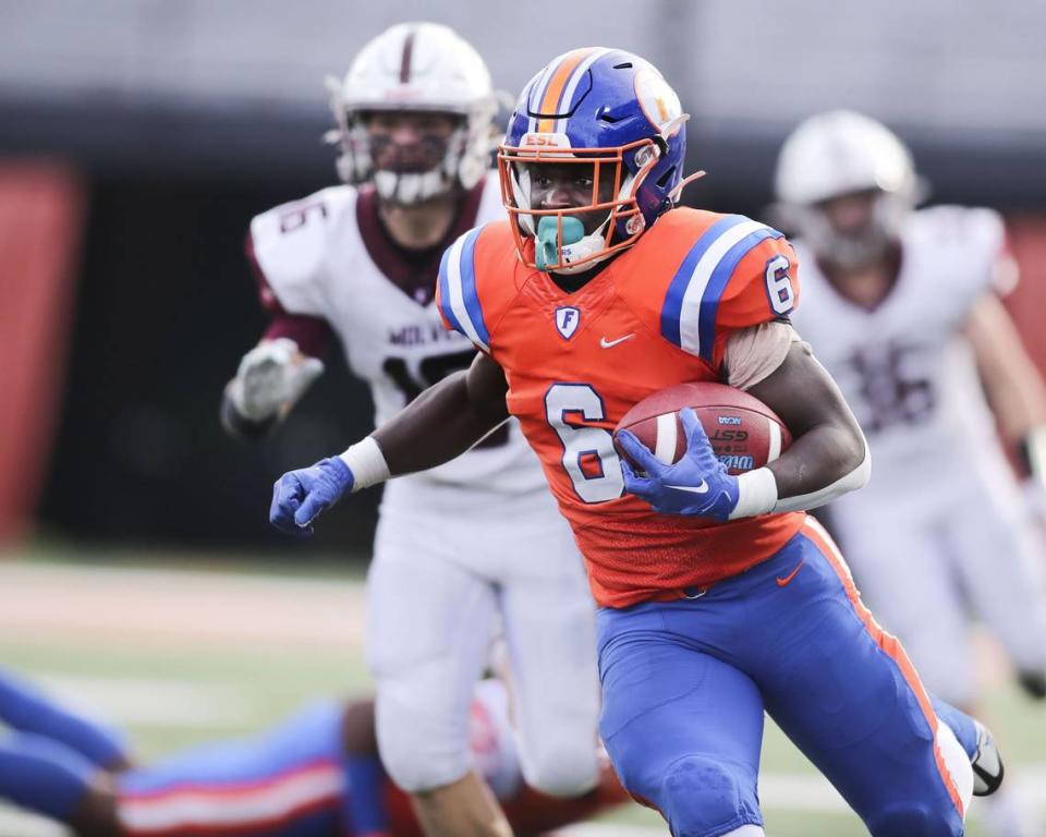 East St. Louis running back TaRyan Martin carries the ball during the IHSA Class 6A state championship game against Prairie Ridge.