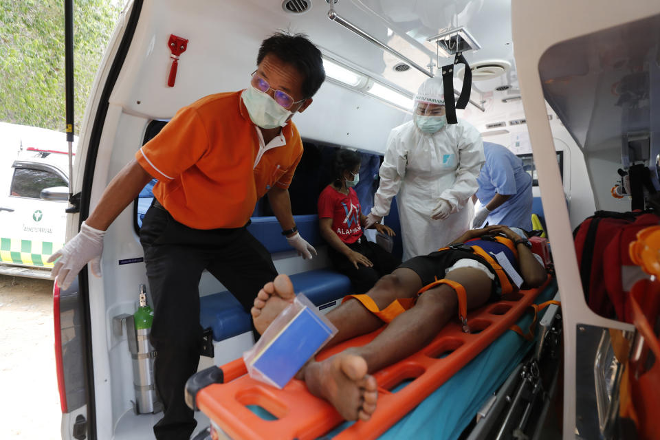 An injured Karen villager from Myanmar is attended by medical workers after they crossed Salawin river on a boat, at Ban Mae Sam Laep Health Center, Mae Hong Son province, Thailand on Tuesday March 30, 2021. The weekend strikes by the Myanmar military, which sent ethnic Karen people seeking safety in Thailand, represented another escalation in the violent crackdown by Myanmar’s junta on protests of its Feb. 1 takeover.(AP Photo/Sakchai Lalit)