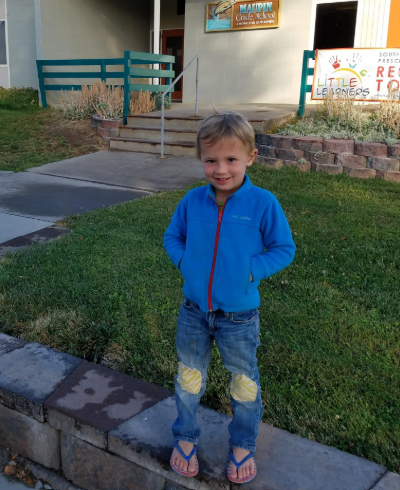 Max Carver stands outside of a preschool.