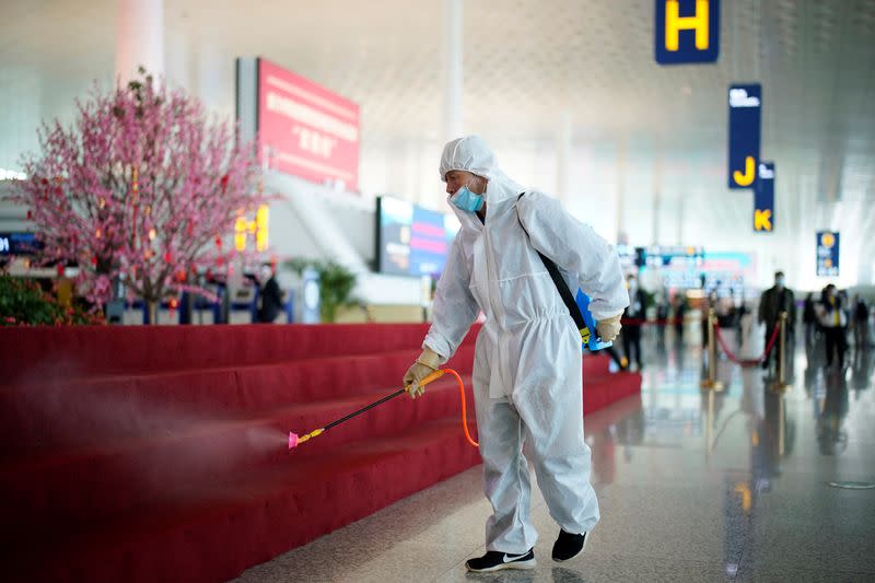 Worker in protective suit disinfects the Wuhan Tianhe International Airport