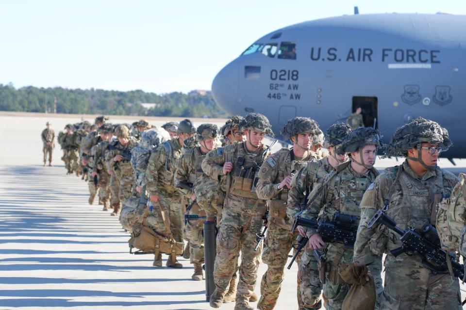 This handout picture released by the US Army shows U.S. Army Paratroopers assigned to the 2nd Battalion, 504th Parachute Infantry Regiment, 1st Brigade Combat Team, 82nd Airborne Division, deploy from Pope Army Airfield, North Carolina on January 1, 2020. - Paratroopers from 2nd Battalion, 504th Parachute Infantry Regiment, 1st Brigade Combat Team, 82nd Airborne Division were activated and deployed to the U.S. Central Command area of operations in response to recent events in Iraq. (Photo by Capt. Robyn Haake / US ARMY / AFP) / RESTRICTED TO EDITORIAL USE - MANDATORY CREDIT "AFP PHOTO / Capt. Robyn J. Haake / US ARMY " - NO MARKETING - NO ADVERTISING CAMPAIGNS - DISTRIBUTED AS A SERVICE TO CLIENTS (Photo by CAPT. ROBYN HAAKE/US ARMY/AFP via Getty Images)