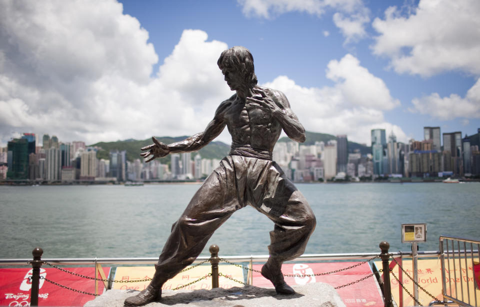 01 July 2008, Hong Kong, China --- Bronze statue of Bruce Lee at the Avenue of the Stars, Tsim Sha Tsui, Kowloon, in a sunny day, Hong Kong, China. Photo by Victor Fraile --- Image by © Victor Fraile (Photo by Victor Fraile/Corbis via Getty Images)