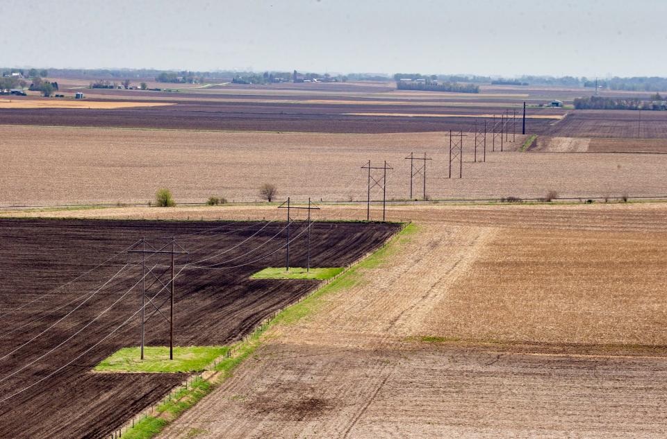 High-voltage transmission lines are seen from a helicopter as Ryan Hansen with MidAmerican Energy inspects the lines around the Fort Dodge area in Iowa on Thursday, May 12, 2022.