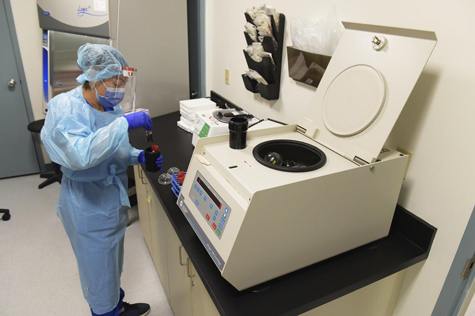 A lab tech at the University of Miami Miller School of Medicine processes blood samples from study participants who volunteered to take part in testing the NIH-funded Moderna Covid-19 vaccine in Miami, Florida, September 2, 2020. Miami is one of 89 cities around the U.S. taking part in the study as part of the third phase of a clinical trial.