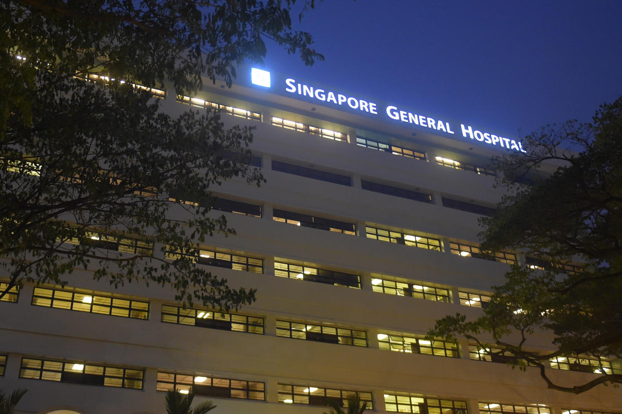 The windows of wards are seen with the sign of Singapore General Hospital on Tuesday, Oct. 6, 2015 in Singapore.  The top public hospital in Singapore said Tuesday that four of its patients died after a new renal ward was hit by an outbreak of hepatitis C, likely from intravenous treatment. (AP Photo/Joseph Nair)