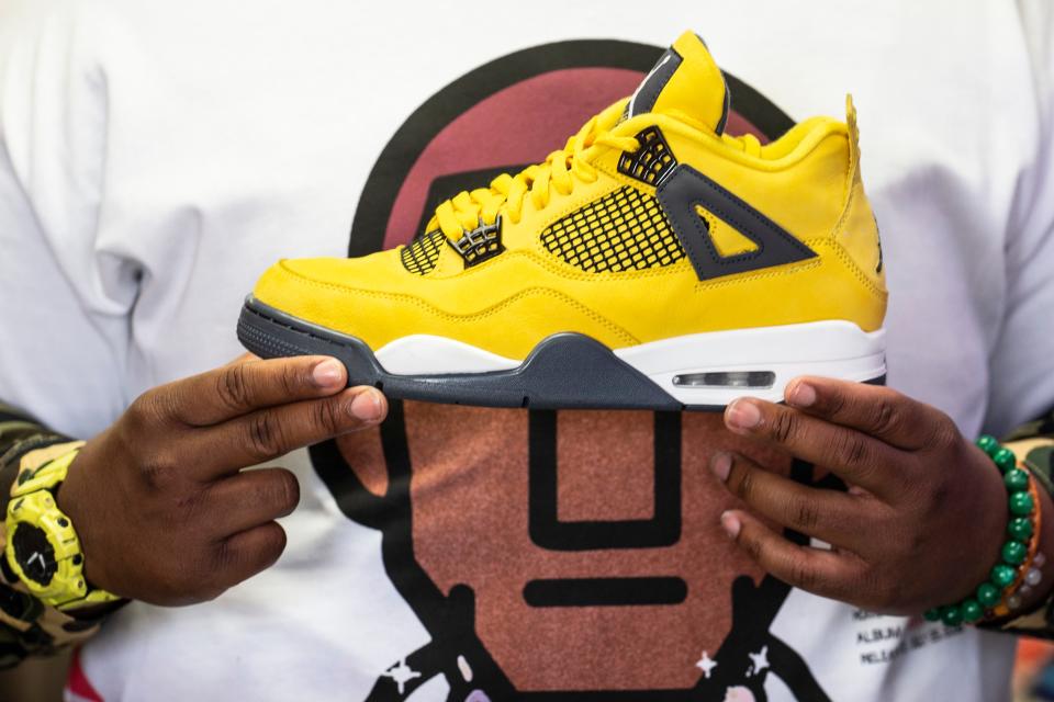 Ryan Johnson, 26, of Wilmington, shows the Air Jordan 4 Retro Lighting for sale at his 10kthelongway sneaker store in Newark on Monday, Feb. 20, 2023. Johnson has been reselling shoes since he was a teen and is the creator of the SneakPeekConvention that will be held at Stubbs Early Education Center in Wilmington on Feb. 25.