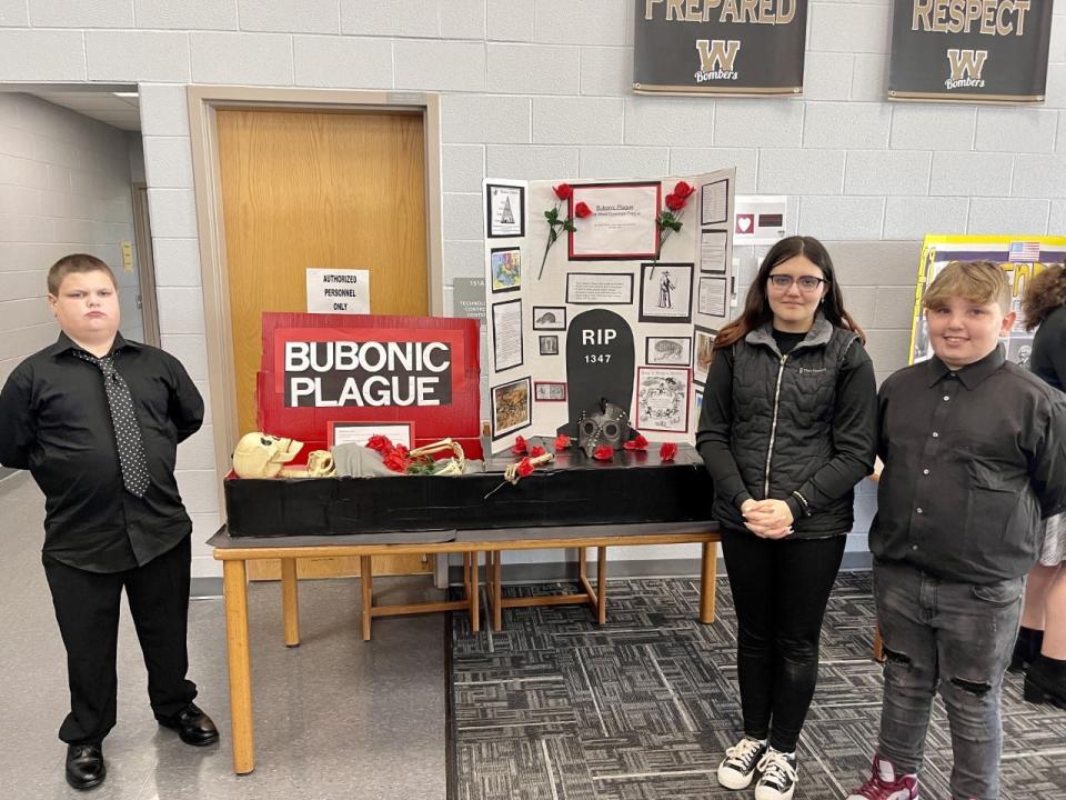 Seventh graders, from left, Kohl Clark, Jaiden Moore and Malikye Petrich presented a project on the bubonic plague at Windham Junior High School.