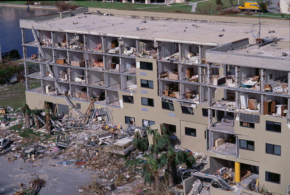 <p>Piles of rubble lay outside a Saga Bay condominium following Hurricane Andrew. (Steve Starr/CORBIS/Corbis via Getty Images) </p>