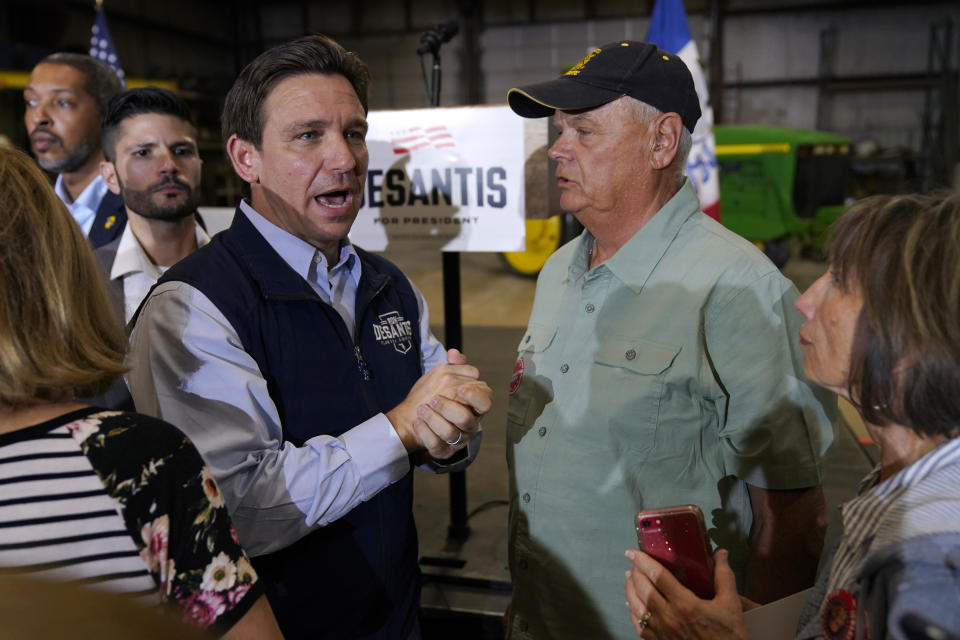 Republican presidential candidate Florida Gov. Ron DeSantis talks with an audience member during a campaign event at Port Neal Welding, Wednesday, May 31, 2023, in Salix, Iowa. (AP Photo/Charlie Neibergall)