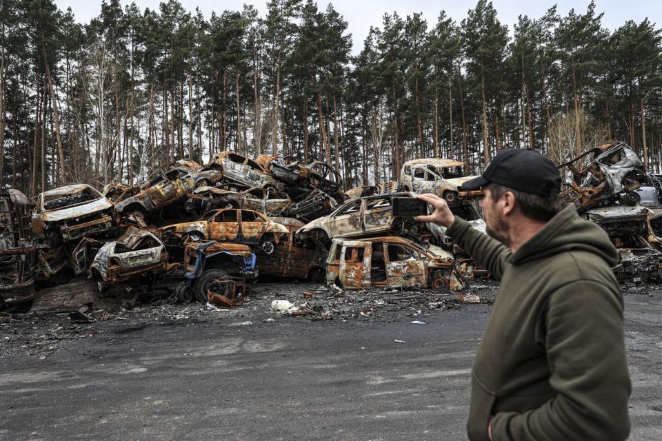 A view of cars destroyed and burned during the war between Ukraine and Russia, piled up on the roadside in the city center of Irpin, Ukraine on April 21, 2022. (Metin Aktas/Anadolu Agency via Getty Images)
